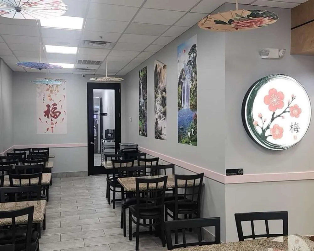 Wall‑mounted plum blossom lighted sign inside dining room at Mei Garden Asian Cuisine, a Asian Restaurant in Sugar Land